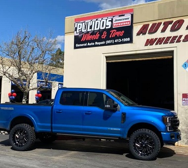 blue truck in front of Pulidos Wheels and Tires garage